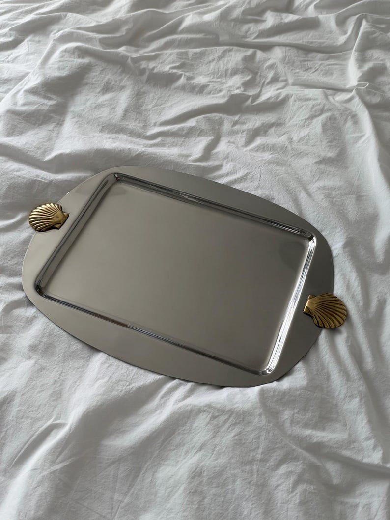 Ornate silver serving tray with shell handles