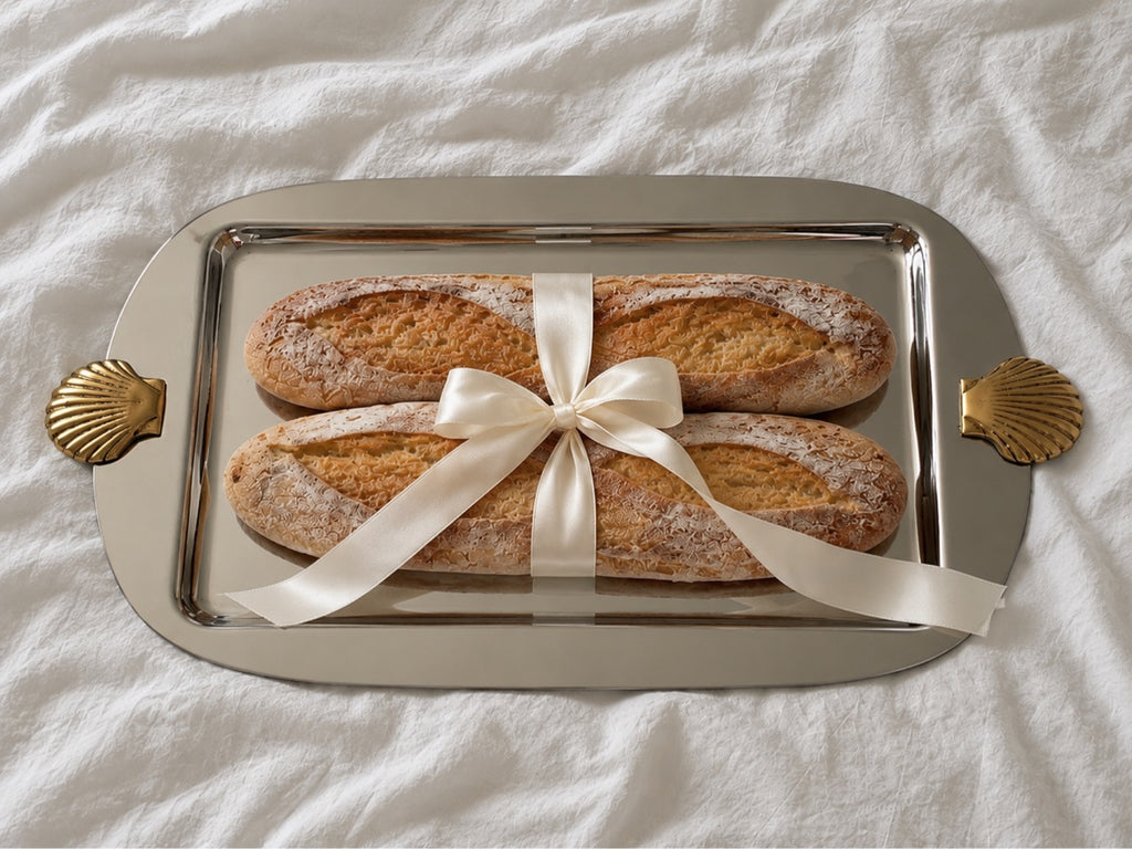 Silver serving tray with ribbon-tied baguettes