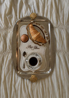Silver serving tray with croissant and coffee, portrait